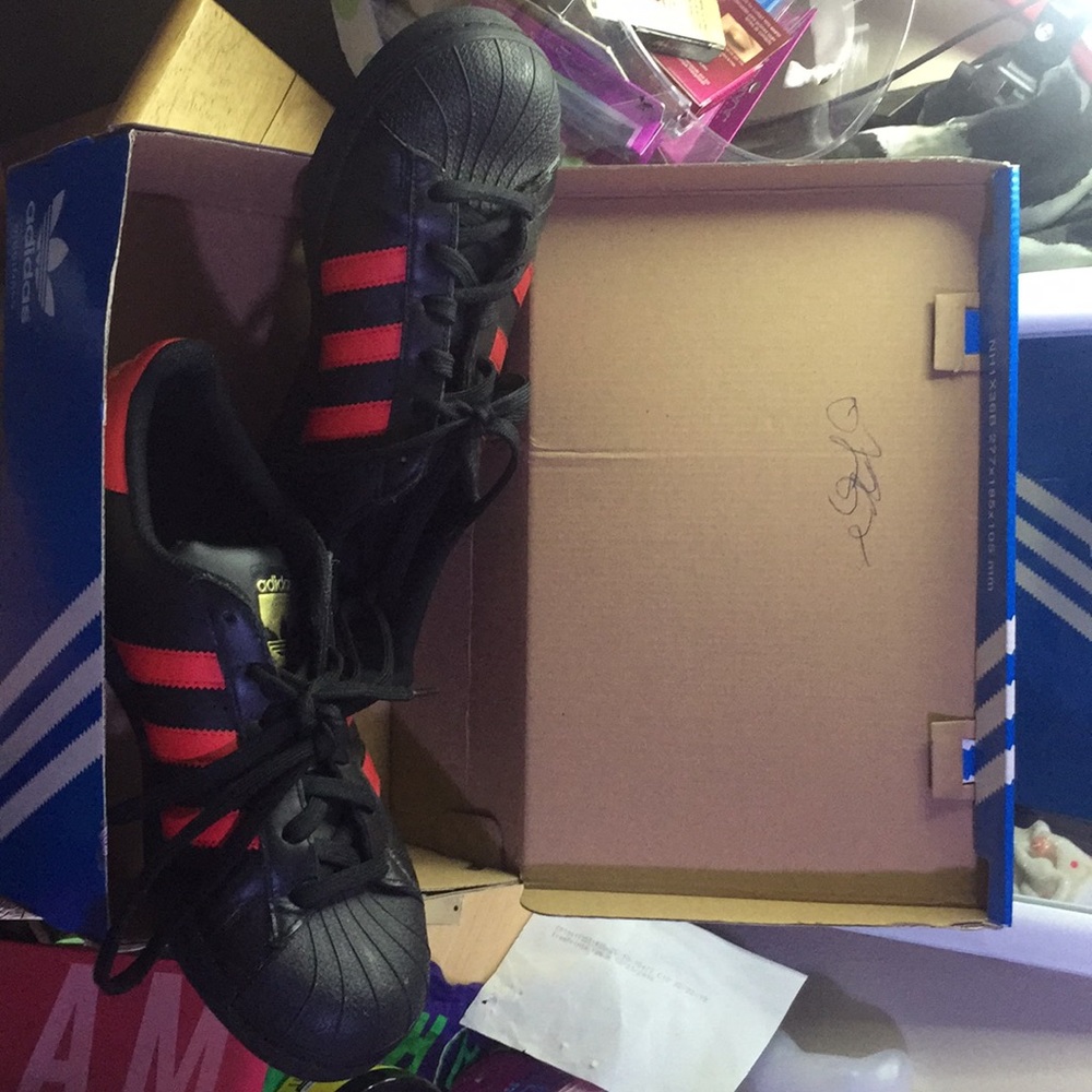 Red and black adidas superstars